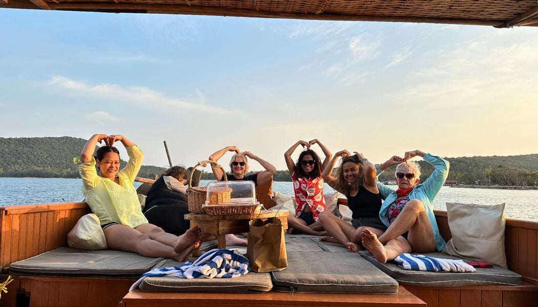 Group of ladies enjoy sunset on a boat in the Cambodia islands