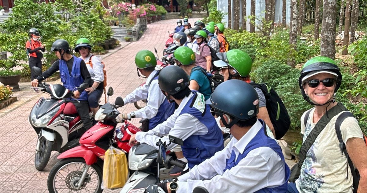 Group taking off on scooter tour in Vietnam