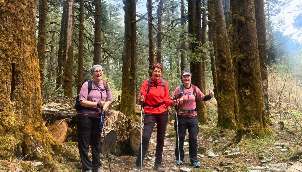 Happy group trekking through forest in Nepal-1