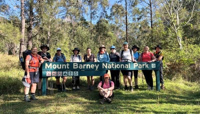 Ladies Trekking group at sign for Mt Barney National Park