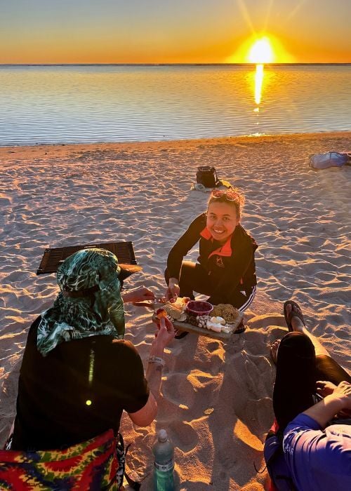 Marie on the beach with food