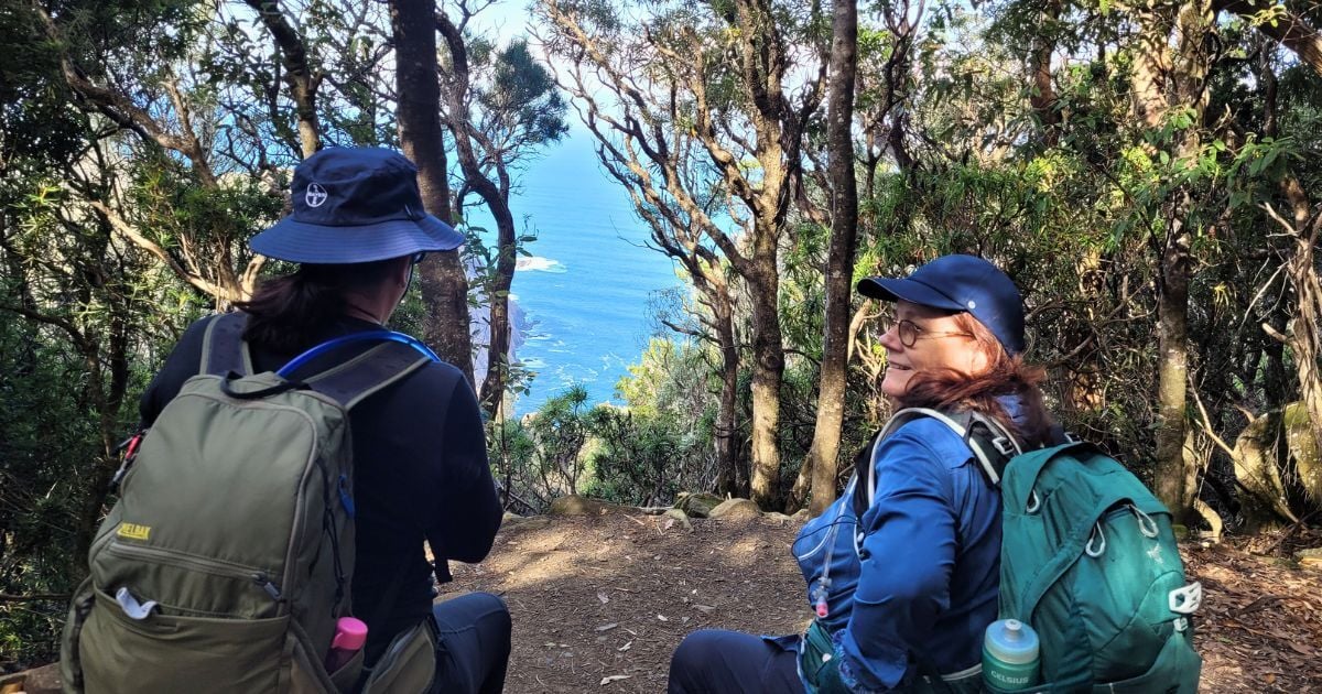 Pausing for a coastal view while hiking in Tasmania