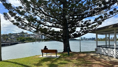 Woman sitting on a bench in New Farm Park