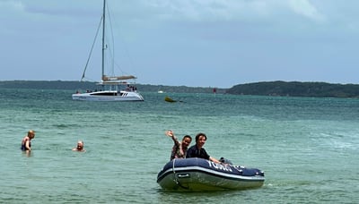 Woman waving from the dinghy