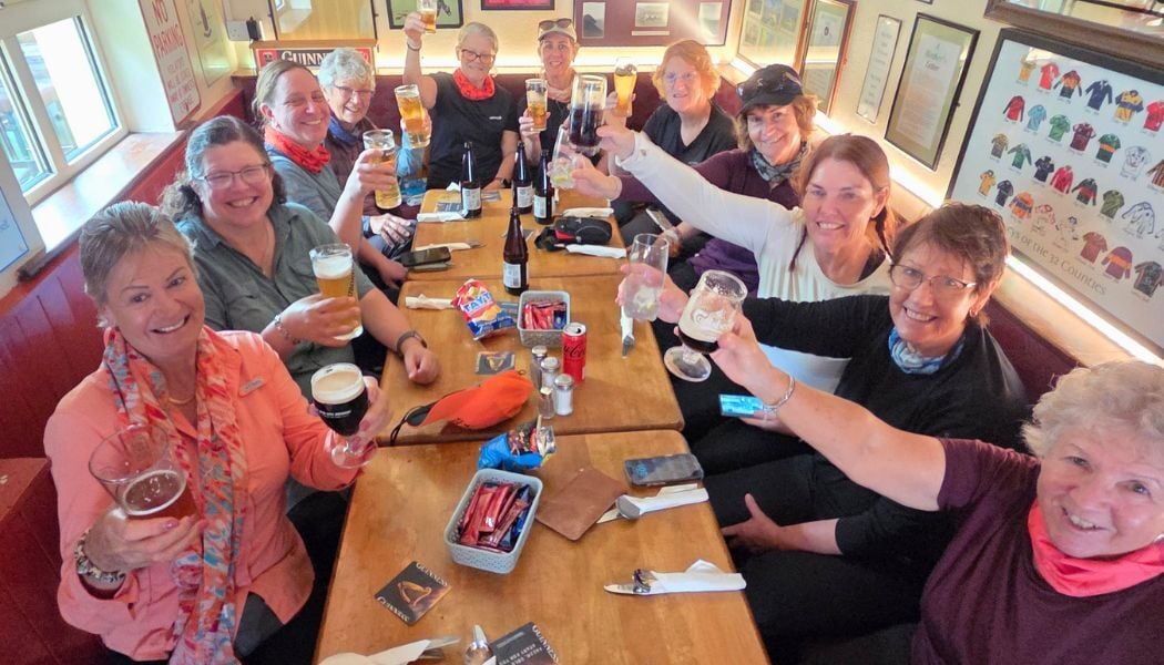 Women enjoying cold drinks after a hike