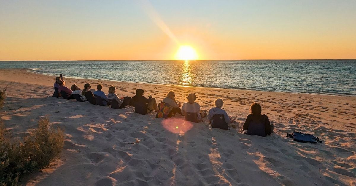 Womens tour group watches sunset at Ningaloo Reef