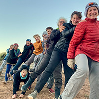 women hikers with leg outstretched 