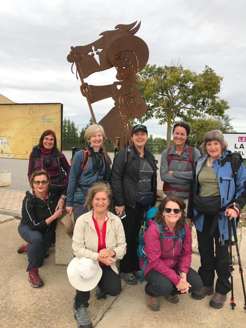 Maria and friends standing in front of a metal statue of a knight and horse on the camino