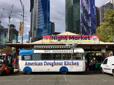 Hot doughnut bus parked outside night markets